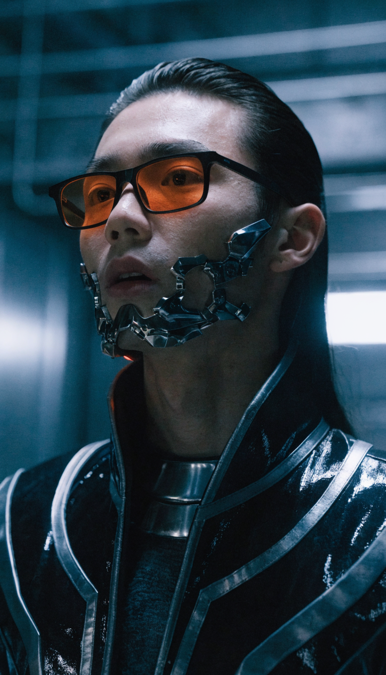 Cinematic photography. Shot on Sony Venice, Hawk V-Lite, 14 mm. create a photo-realistic picture of a man with slicked back black hair, he wears orange toned black glasses like in the Matrix, he wears a sci fi suit and has a weird metal construct around his mouth
